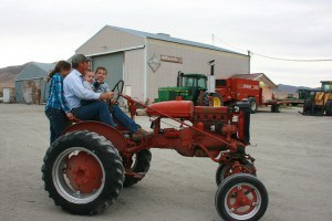 Joseph giving kids ride on tractor