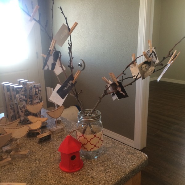 Family tree using ancestor photos, tree branches, and mini clothespins in a jar.