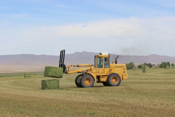 Sam stacking bales