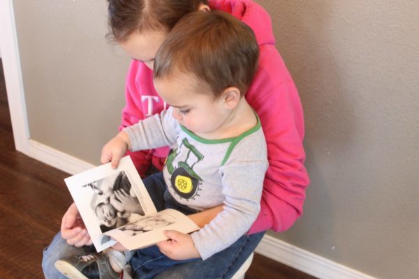 child looking at chatbook photo book